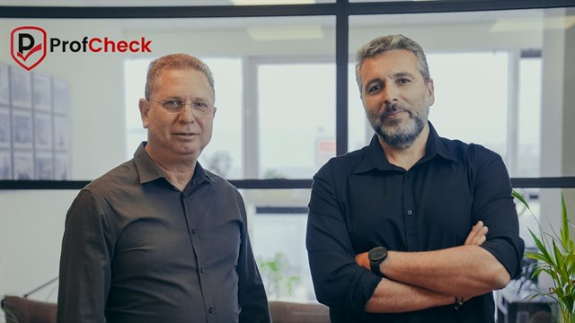 Ofer Reiss and Ofir Malka, founders of ProfCheck, standing together in their office.